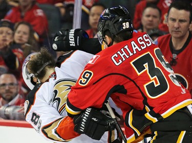 Calgary Flames' Alex Chiasson and Anaheim Ducks' Patrick Eaves tangle along the boards during game 3 of their Stanley Cup playoff series at the Scotiabank Saddledome on Monday April 17, 2017.