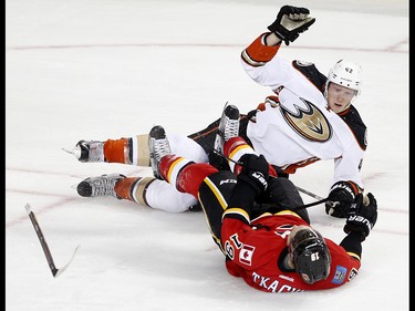 Anaheim Ducks Josh Manson and Calgary Flames Matthew Tkachuk collide during NHL playoff action at the Scotiabank Saddledome in Calgary, Alta. on Monday April 17, 2017. Leah Hennel/Postmedia