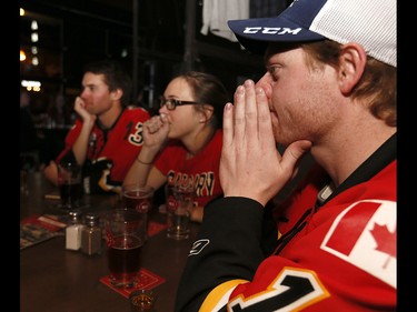 Calgary Flames fans reacts as the Ducks scored scored in OT to beat the Calgary Flames in game 3 at Trolley 5 Restaurant and Brewery on the Red Mile on Monday April 17, 2017. DARREN MAKOWICHUK/Postmedia Network