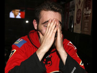 Calgary Flames fans reacts as the Ducks scored scored in OT to beat the Calgary Flames in game 3 at Trolley 5 Restaurant and Brewery on the Red Mile on Monday April 17, 2017. DARREN MAKOWICHUK/Postmedia Network