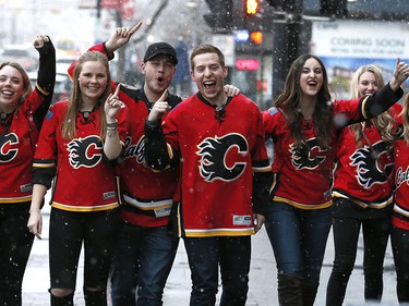 Calgary Flames fans brave the snow as they head to The National to cheer on their team on the Red Mile on Saturday April 15, 2017. DARREN MAKOWICHUK/Postmedia Network