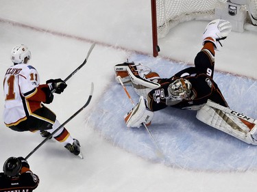 Calgary Flames center Mikael Backlund, left, scores past Anaheim Ducks goalie John Gibson during the first period in Game 2 of a first-round NHL hockey Stanley Cup playoff series in Anaheim, Calif., Saturday, April 15, 2017. (AP Photo/Chris Carlson) ORG XMIT: ANA108