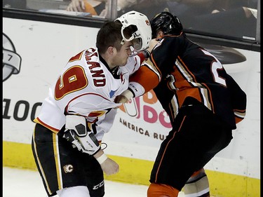 Calgary Flames left wing Micheal Ferland fights with Anaheim Ducks defenseman Kevin Bieksa during the second period in Game 2 of a first-round NHL hockey Stanley Cup playoff series in Anaheim, Calif., Saturday, April 15, 2017. (AP Photo/Chris Carlson) ORG XMIT: ANA113