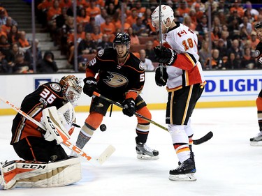 ANAHEIM, CA - APRIL 15: Shea Theodore #53 and John Gibson #36 of the Anaheim Ducks defend against a shot as Matt Stajan #18 of the Calgary Flames looks on during the second period of Game Two of the Western Conference First Round during the 2017 NHL Stanley Cup Playoffs at Honda Center on April 15, 2017 in Anaheim, California.  (Photo by Sean M. Haffey/Getty Images)