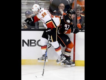 Calgary Flames right wing Troy Brouwer, left, checks Anaheim Ducks defenseman Hampus Lindholm during the third period in Game 2 of a first-round NHL hockey Stanley Cup playoff series in Anaheim, Calif., Saturday, April 15, 2017. (AP Photo/Chris Carlson) ORG XMIT: ANA117