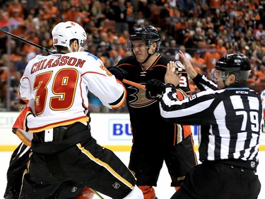 ANAHEIM, CA - APRIL 15:  Alex Chiasson #39 of the Calgary Flames hits Jakob Silfverberg #33 of the Anaheim Ducks as linesman Kiel Murchison intervenes during the second period of Game Two of the Western Conference First Round during the 2017 NHL Stanley Cup Playoffs at Honda Center on April 15, 2017 in Anaheim, California.  (Photo by Sean M. Haffey/Getty Images)
