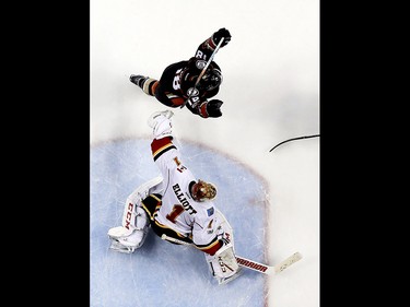 Anaheim Ducks right wing Patrick Eaves, top, celebrates Ryan Getzlaf's go-ahead goal past Calgary Flames goalie Brian Elliott during the third period in Game 2 of a first-round NHL hockey Stanley Cup playoff series in Anaheim, Calif., Saturday, April 15, 2017. (AP Photo/Chris Carlson) ORG XMIT: ANA122