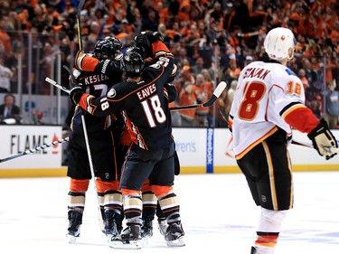 ANAHEIM, CA - APRIL 15:  Ryan Getzlaf #15 is congratulated by Patrick Eaves #18 and Ryan Kesler #17 of the Anaheim Ducks as Matt Stajan #18 of the Calgary Flames skates past during the third period of Game Two of the Western Conference First Round   during the 2017 NHL Stanley Cup Playoffs at Honda Center on April 15, 2017 in Anaheim, California.  (Photo by Sean M. Haffey/Getty Images)