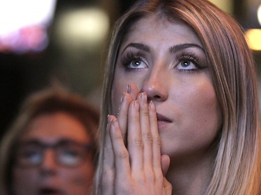 Calgary Flames fan Sydney Melhoff prays in the dying seconds as the Anaheim Ducks beat the Calgary Flames 3-2 at Trolley 5 Restaurant and Brewery on the Red Mile on Saturday April 15, 2017. DARREN MAKOWICHUK/Postmedia Network