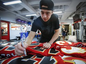 Calgary Flames' Johnny Gaudreau signs autographs at the team's locker clean out day in Calgary, Friday, April 21, 2017.