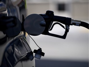 A nozzle pumps fuel into the gas tank of a car at a Chevron Corp. gasoline station.