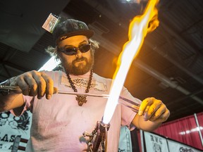 Troy McDonald of Olds, Alberta blows glass pipes at the Edmonton Cannabis and Hemp Expo at the Edmonton Expo Centre on April 1, 2017.