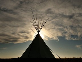 FILE -- SIKSIKA, AB: OCTOBER 2, 2009 -- Wispy clouds form above a teepee at Blackfoot Crossing Historical Park on the Siksika Nation Reserve in Alberta in this October 2, 2009 file photo.