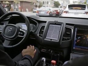 In this photo taken Tuesday, Dec. 13, 2016, an Uber driverless car waits in traffic during a test drive in San Francisco. Uber is bringing a small number of self-driving cars to its ride-hailing service in San Francisco - a move likely to both excite the city's tech-savvy population and spark a conflict with California regulators. The Wednesday, Dec. 14, launch in Uber's hometown expands a public pilot program the company started in Pittsburgh in September.