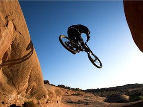 A mountain biker takes to the air in the early morning.