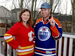 Katie and husband Adam Vanderwoude have some good natured fun at their southwest Calgary, Alta homeon Tuesday April 18, 2017. Katie is Flames and Adam is a diehard Oilers fan and have been cheering on their teams in the NHL playoffs. Jim Wells//Postmedia
