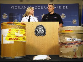 L-R, Canada Border Service Agency Chief Candace Lyle and Calgary Police Service Staff Sgt. Mark Hatchette display some of the seized items as the Calgary Police Service Investigative Operations Section has charged two people after an investigation led to the seizure of a record amount of phenacetin on Wednesday April 26, 2017. DARREN MAKOWICHUK/Postmedia Network