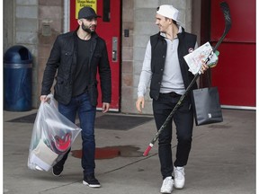 Calgary Flames Mark Giordano, left, and Mikael Backlund leave the Saddledome on the team's locker clean out day in Calgary on April 21, 2017. (The Canadian Press)