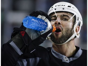 Calgary Flames' Mark Giordano takes a water break during a team practice in Calgary, Monday, April 10, 2017. The Flames will play the Anaheim Ducks in the first round of the NHL playoffs.