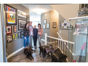 Darren and Sharon Anderson. with their daughter Darci, Darren's mom Shirley Ferrier, and their dog Ace in their home by Sterling Homes in Nolan Hill. The home is decorated to reflect the couple's passion for Rock and Roll music.