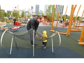 Thomas Tracey plays with his son Owen in the  natural playground is shown in East Village in southeast Calgary, Alta on Saturday May 21, 2016. Jim Wells//Postmedia
