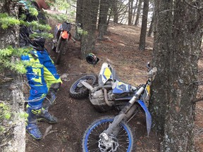A dirt bike lays on the ground after a close encounter with barbed wire in Porcupine Hills.