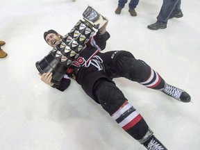 University of New Brunswick Varsity Reds' Philippe Maillet falls to the ice with the University Cup after defeating the St. Francis Xavier X-Men 3-1 to win the U Sports hockey championship in Halifax on March 20, 2016. Hockey players Sarah Bujold of St. Francis Xavier University and Maillet of the University of New Brunswick are among the finalists for the 25th annual BLG Awards. (The Canadian Press)