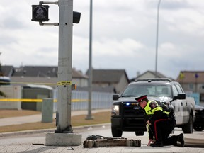 Police investigate the scene of a fatal pedestrian collision at the intersection of 52 street and 52 avenue SE in Calgary, Alta., on Friday April 14, 2017. Leah Hennel/Postmedia