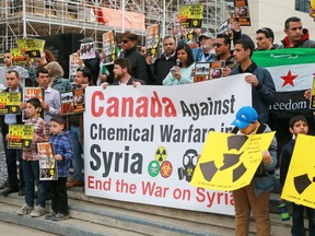About a hundred people gathered to protest the recent chemical weapons attack in Syria during a rally outside Calgary City Hall on Wednesday April 5, 2017. Gavin Young/Postmedia Network