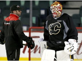 Calgary Flames goalie Brian Elliott with goaltending coach Jordan Sigalet during NHL practice at the Scotiabank Saddledome in Calgary, Alta., on Tuesday, April 18, 2017.