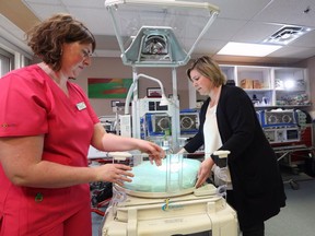 Foothills Hospital NICU Clinical Resource Nurse Michelle Clapperton, left and NICU manager Marjorie Bickell demonstrate some of the features of the high-tech Giraffe incubator for premature newborns.