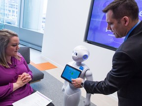 ATB Financial introduced a $20,000 robot called Pepper which will engage with customers at select ATB branches in Calgary starting this May. The unveiling took place at the 8th Avenue Place branch in downtown Calgary on Tuesday April 25, 2017. Gavin Young/Postmedia Network