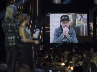 Presenters watch as a video of Gord Downie is played after he won the Songwriter of the Year at the Juno awards show Sunday April 2, 2017 in Ottawa.