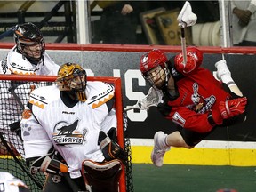 Calgary Roughnecks Curtis Dickson, right, scores on New England Black Wolves net minder Evan Kirk at the Scotiabank Saddledome in Calgary, Alta. on Saturday March 25, 2017. Dickson had three goals in a win at the Rochester Knighhawks on Saturday.