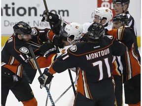 Anaheim Ducks center Ryan Kesler, left, fights Calgary Flames center Sean Monahan, second from left, as defenceman Brandon Montour (71) and left wing Andrew Cogliano, right, pull on defenceman T.J. Brodie, third from right, in Anaheim, Calif., on April 4, 2017. The Ducks won 3-1. (AP Photo)
