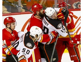 Mikael Backlund, left, Deryk Engelland and Matt Bartkowski of the Calgary Flames tussle with Antoine Vermette and Corey Perry of the Anaheim Ducks in Calgary on Sunday, April 2, 2017. (Lyle Aspinall)