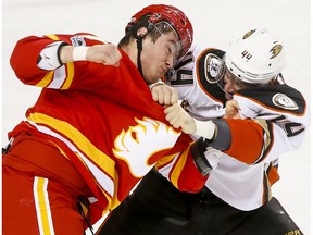 Micheal Ferland, left, of the Calgary Flames fights Nate Thompson of the Anaheim Ducks in Calgary on Sunday, April 2, 2017. (Lyle Aspinall)