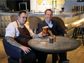 Sean Cutler, chef de cuisine at the new Oxbow Restaurant in Kensington Riverside Inn, with Mark Wilson, vice-president and general manager of Hotel Arts Group, the inn's owner, seated in the new lounge.