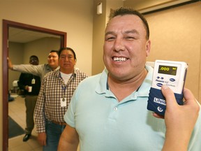 Reuben Breaker, Siksika Band Councillors and Chair of the Crime Prevention Task Force gets a drug test from Robyn Ainsworth from Dynamic Testing Solutions as part of the Siksika Nation council voluntary drug testing initiative to deter drug use in the community on Monday April 24, 2017. DARREN MAKOWICHUK/Postmedia Network