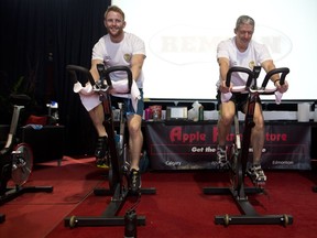 Rory Thompson, event organizer, left, and Scott MacDonald cycle during the 24 hour Spin for a Veteran at  CP head office in Calgary, Alta., on Wednesday April 26, 2017. The goal is to raise a minimum of $60,000 to support a new initiative of Canadian Legacy Project which is focused on providing transitional housing to Canadian veterans in need. Leah Hennel/Postmedia