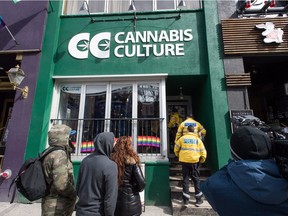 Store employees, media, and supporters are seen outside the Cannabis Culture store on Church Street during a police raid in Toronto on Thursday, March 9, 2017. Prominent marijuana activists Marc and Jodie Emery have been arrested in Toronto and police are raiding several pot dispensaries associated with the couple.THE CANADIAN PRESS/Aaron Vincent Elkaim ORG XMIT: AVE101