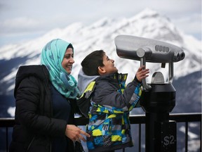 Syrian refugee Lina Hejazi, 32, and her son Khaled Hussain, 6, look out at the mountains in Banff during a recent sponsored visit. Reader says we need to understand what new arrivals to the country have been through.