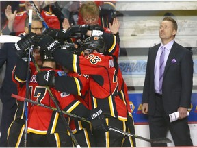 The Flames and coach Glen Gulutzan celebrate the win following NHL action between the San Jose Sharks and the Calgary Flames in Calgary, Alta. on Friday March 31, 2017. The Flames officially qualified for the playoffs.