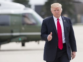 US President Donald Trump gives a thumbs-up as he walks to Marine One at General Mitchell International Airport in Milwaukee, Wisc., April 18, 2017, prior to returning to Washington following a trip to Kenosha, Wisconsin, to speak at Snap-On Tools.