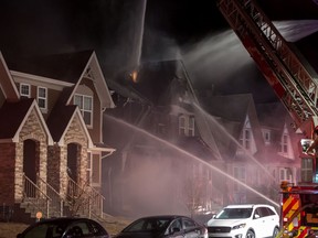 Members of the Calgary Fire Department work to contain a blaze that broke out inside a duplex on Cranford Park, S.E. around 11 p.m. Thursday, April 6, 2017. (Photos by Darek Lasota/Mobius Photography)