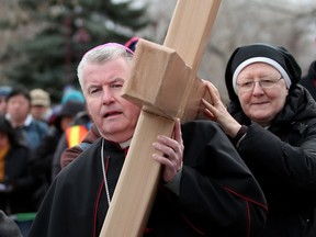 Bishop William McGrattan, left and sister Dianne Turner leave St. Mary's Cathedral during way of the cross on Good Friday in Calgary, Alta., on Friday April 14, 2017. Leah Hennel/Postmedia