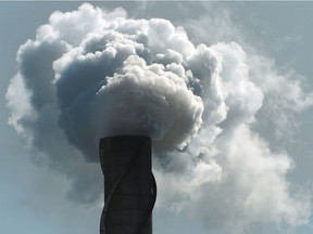 (FILES) In a file photo taken on October 12, 2006 smoke and steam billows from an exhaust stack at a Queensland sugar refinery in Ayr.  Australia's controversial pollution tax looked all but certain to pass after a key lawmaker on July 8, 2011 confirmed that he would support the package, which aims to reduce emissions blamed for climate change. Prime Minister Julia Gillard is on July 10 due to unveil the full detail of her deeply contested carbon tax, which will see the country's top 500 polluters charged per tonne of carbon dioxide they emit into the atmosphere.  AFP PHOTO/Paul CROCK (Photo credit should read PAUL CROCK/AFP/Getty Images)