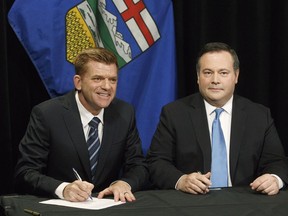 Alberta Wildrose leader Brian Jean and Alberta PC leader Jason Kenney sign a unity deal between the two in Edmonton on Thursday, May 18, 2017. THE CANADIAN PRESS/Jason Franson ORG XMIT: EDM105