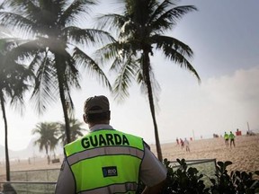 FILE - In this June 15, 2014, file photo, a policeman stands guard along the Copacabana beach in Rio de Janeiro, Brazil. Despite the seeming abundance of riches for travelers, Brazil has a tourism problem. While you may have heard about the Amazon or the stunning beaches of Rio de Janeiro, you have probably also heard that Brazil has high crime, was swept by a Zika outbreak and that its politicians have concocted the largest graft scheme in Latin American history. (AP Photo/Wong Maye-E, File)
