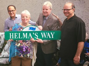 Helma Dahlman is recognized for 50 years of volunteer service with her very own street sign. Making the presentation were, from left, Finance Minister Joe Ceci, Dahlman, the City of Calgary's Merle Jensen and city manager Jeff Fielding.   ORG XMIT: XXQtxo0DgOPo2svjD_SH